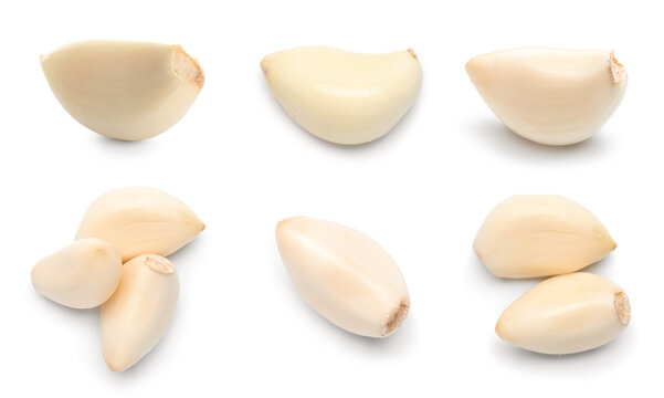 Set of fresh garlic cloves on white background