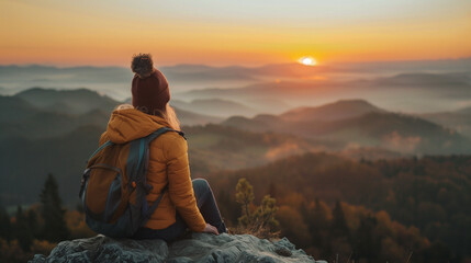 woman meditating on the mountains on the sunrise