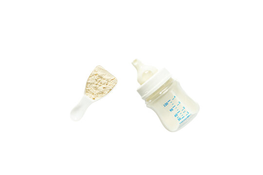 Powdered infant formula in a scoop and baby milk bottle on white background. Top view. Isolated on transparent background, png