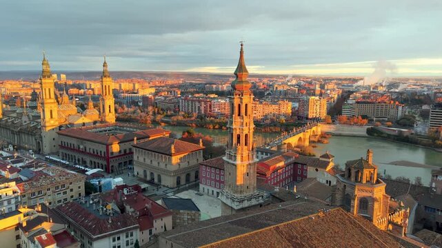 Aerial View Capturing Sunset Glow Illuminating Cathedral Domes And Tranquil River Reflections. Zaragoza. Spain 