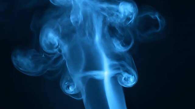 A beautiful and mesmerizing slow motion shot of a thin stream of blue smoke rising against a dark background