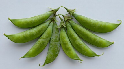A bunch of fresh green peas on a plain background.