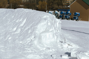 Snow cannon in winter mountains. Snow-gun spraying artificial ice crystals. Machine making snow.