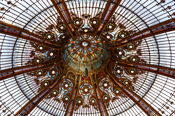 Low angle of the center of the famous 1912 stained glass Art Nouveau dome in the Galeries Lafayette main historic store, Paris, France