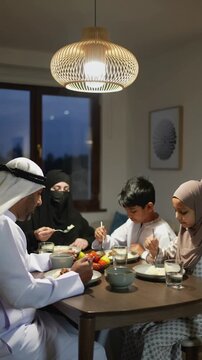 A Muslim family gathered for Iftar in Ramadan - Ramadan pattern, Ramadan background, Ramadan  vibes, Iftar table, iftar time, fasting, food, A-fitr, Suhoor, sunset time, Imsak, Sawm, Siyam, 
