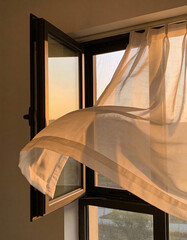 Open Window Curtain Gently Moving in the Evening Breeze, Quiet Emotional Atmosphere, Minimal Storytelling Composition with Soft Natural Light and Calm Introspective Mood