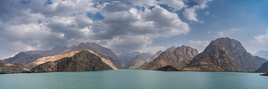 Colorful landscape panorama of turquoise blue Iskanderkul lake in summer, Fann mountains, Sughd, Tajikistan