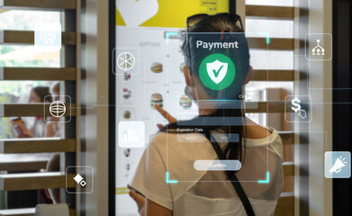 A person interacts with a futuristic self-service payment kiosk, highlighting the concept of digital transactions and modern retail technology with holographic UI icons.