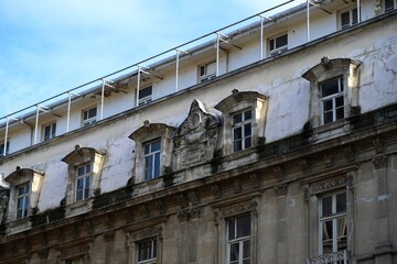 Fototapeta premium Photo of the Exterior Facade of a Historic Building with Stone Carving Decorations 