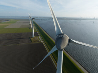 Wind turbines generating clean electricity along a coastline