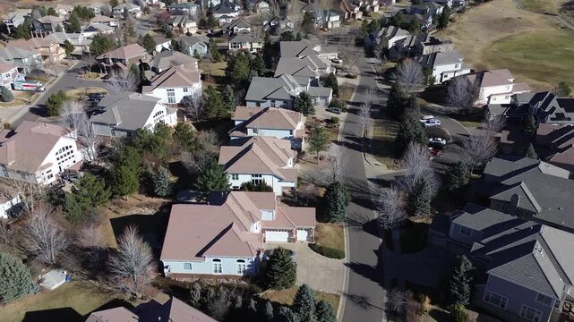 Homes along South Zeno Circle and East Calhoun Drive feature solar panels and varied rooflines. Leafless trees, clean streets, muted tones reflect seasonal quiet, winter scene, Aurora, Colorado