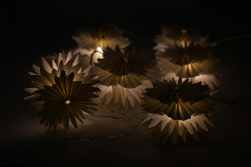 Light garland on a black background. Evening lights.