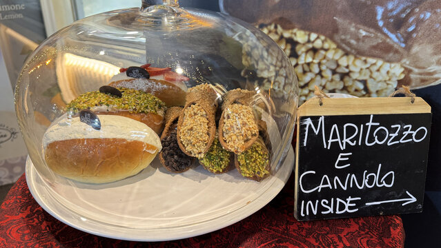 Maritozzo and Cannolo Pastries Displayed Under Glass Dome in Italian Bakery