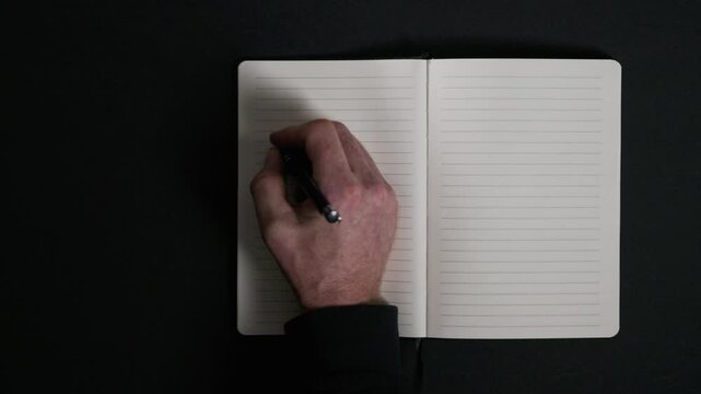 Hand writing in open notebook