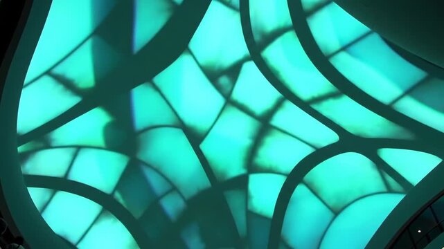 Abstract architectural ceiling design with geometric patterns and illuminated panels creating a modern aesthetic.