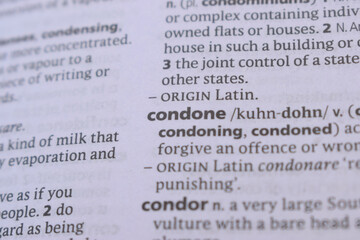 English Dictionary Book Page Close Up With The Word Transcription Of -condone
