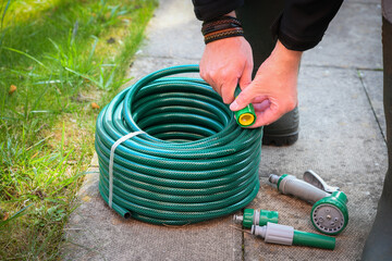 A newly purchased garden hose, still neatly coiled and unused, 