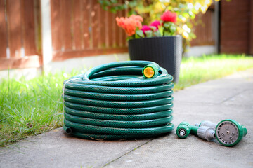 A newly purchased garden hose, still neatly coiled and unused, 