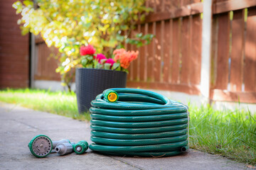 A newly purchased garden hose, still neatly coiled and unused, 