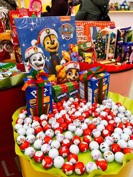 Paw Patrol holiday gift display with wrapped boxes and chocolate eggs in a colorful store scene