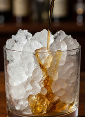 Pouring Whiskey Over Ice Into A Glass With Large Ice Cubes In A Bar Setting