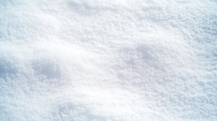 Obraz premium A close-up view of soft, pristine snow covering the ground, reflecting light and creating a serene winter landscape.