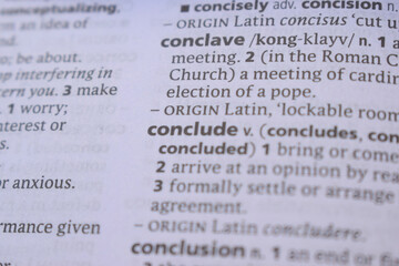 English Dictionary Book Page Close Up With The Word Transcription Of -conclude