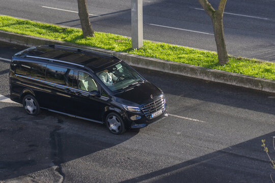 Black mercedes benz v class luxury minivan driving