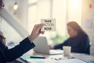 Business meeting in a modern office with a woman holding a motivational note in focus