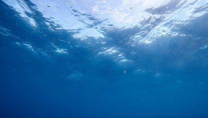 Underwater view of the ocean surface with sunlight filtering through the water