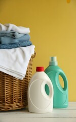 A basket full of laundry detergents and a laundry basket