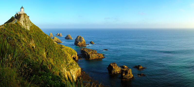 Panorama of Tokata Nugget Point Lighthouse and Pacific Ocean at Nugget Point