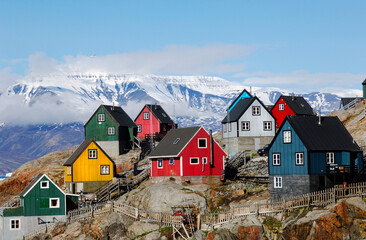Colorful Greenland village with snow covered houses and mountain landscape in winter © benny