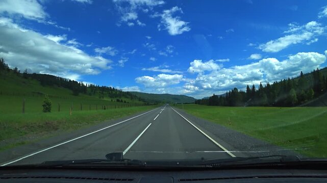 Altai, June 9, 2022: The Chuy Highway is one of the most picturesque roads in the world. A view of the Altai Mountains from a car window. Plains, mountain ranges, and narrow valleys. 4К