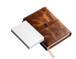 A high-contrast image featuring a rustic brown leather journal next to a stack of blank white business cards against a solid black background.