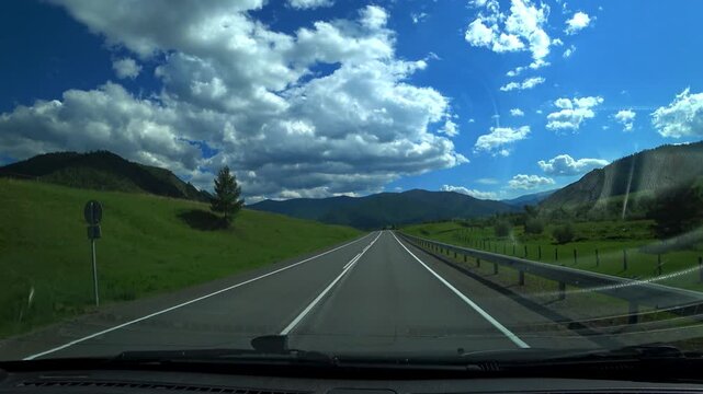 Altai, June 9, 2022: The Chuy Highway is one of the most picturesque roads in the world. A view of the Altai Mountains from a car window. Plains, mountain ranges, and narrow valleys. 4К