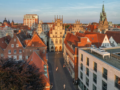 Aerial view of the Prinzipalmarkt's gabled buildings casting long shadows in the warm glow of the setting sun, Munster, North Rhine-Westphalia, Germany.
