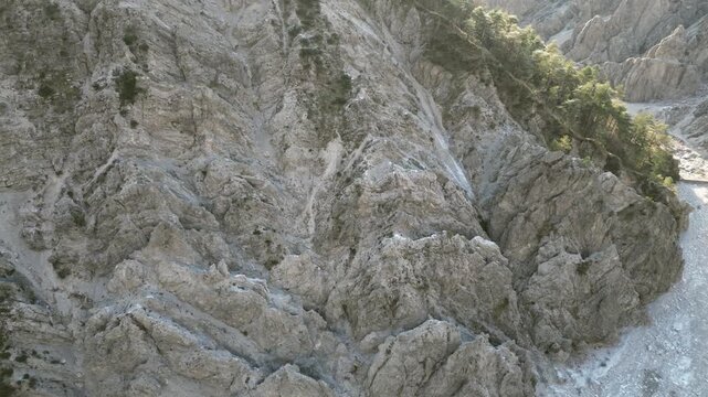 Aerial drone footage over the Susaibes stream near Andreis, Italy: clear water, rocky bed and pristine alpine surroundings. Ideal for nature, travel and scenic stock footage.