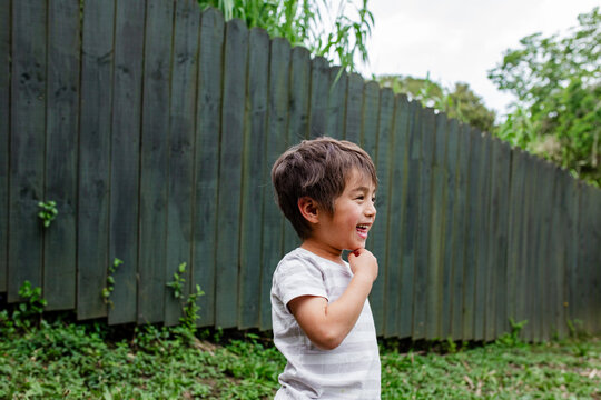 Portrait of happy boy in backyard