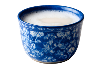 Blue floral cup filled with creamy milk drink, isolated on transparent background