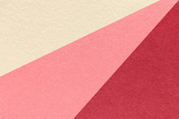 Fototapeta premium Abstract geometric cream pink red paper texture background with diagonal split. Rays pattern decorative backdrop