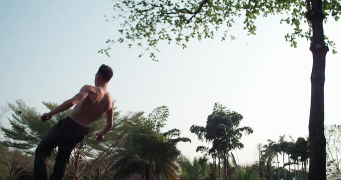 Cinematic time ramp highlights the fluid transition from a handstand to a backflip. Footage slows to 1000fps at sunset, showcasing the beauty of parkour flow. Concept: flow, sunset, cinematic, style