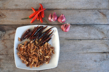 spices an shallots on wooden spoons