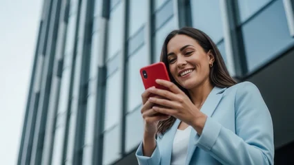 Woman using smartphone with modern building background © Svyatoslav Lypynskyy