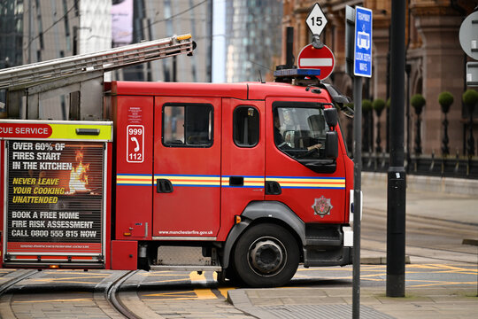 Greater Manchester Fire and Rescue Service fire engine attending a fire call in Manchester city centre