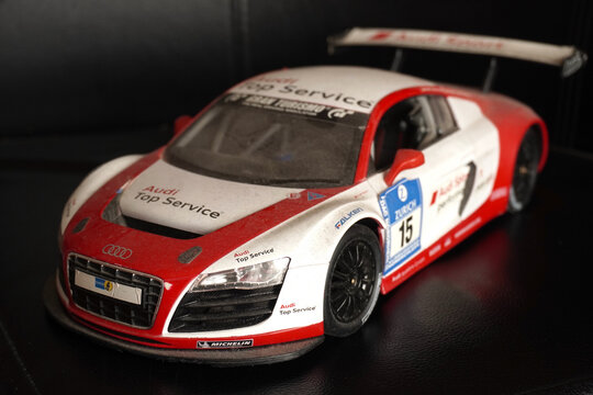 Bucharest, Romania - January 21, 2026 - Dusty scale model of red Audi R8 LMS race car with Top Service Zurich livery, number 15, sponsor logos including Michelin and Falken