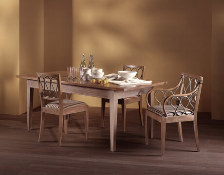 Single shot of a room with dining table and chairs