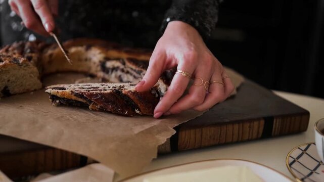 Hands Slicing Delicious Homemade Chocolate Swirl Bread