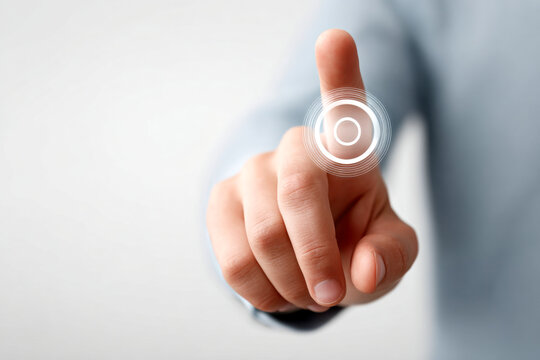 A hand reaches out to touch a digital button, symbolizing interaction and technology in a modern context. - Powered by Adobe