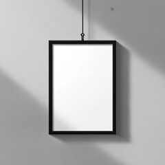 Black framed, blank poster hanging on a gray wall with subtle shadows. Minimalist art concept